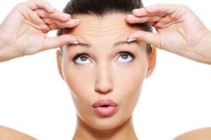 Woman with large lines and wrinkles on her forehead